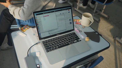 A student interacting with the mintikarjera AI dashboard on a sleek laptop, surrounded by study materials.