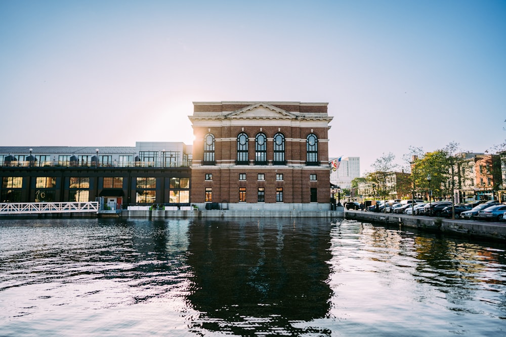 a large brick building sitting on the side of a river