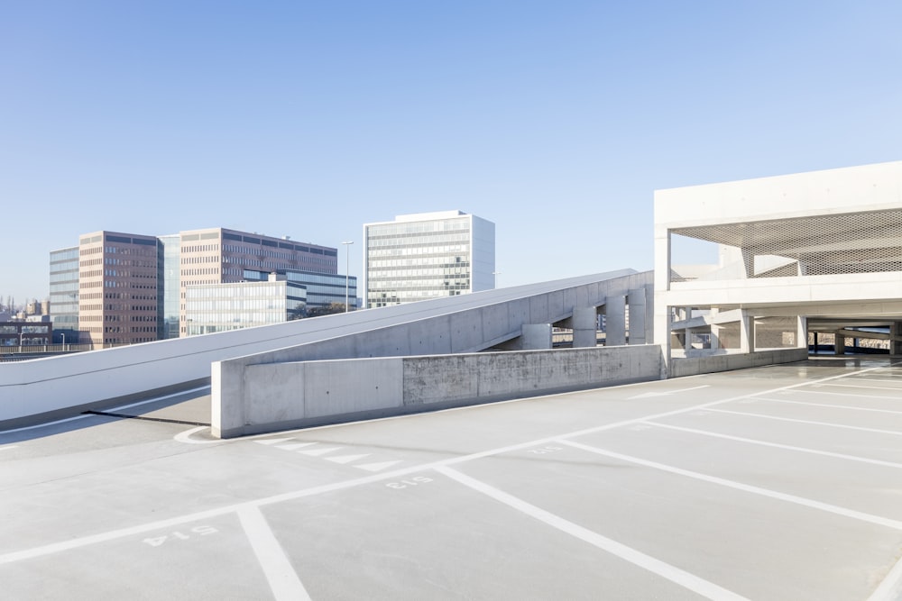 an empty parking lot in front of some buildings