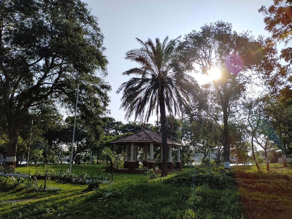 a gazebo in the middle of a lush green park