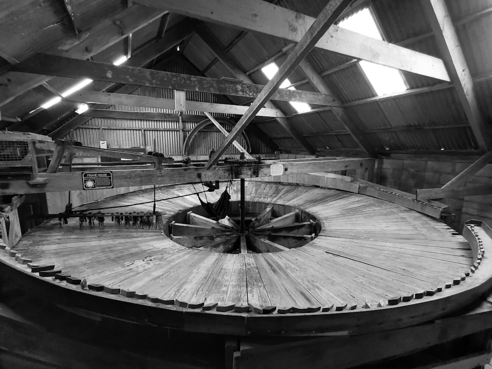 an old spinning wheel inside of a building