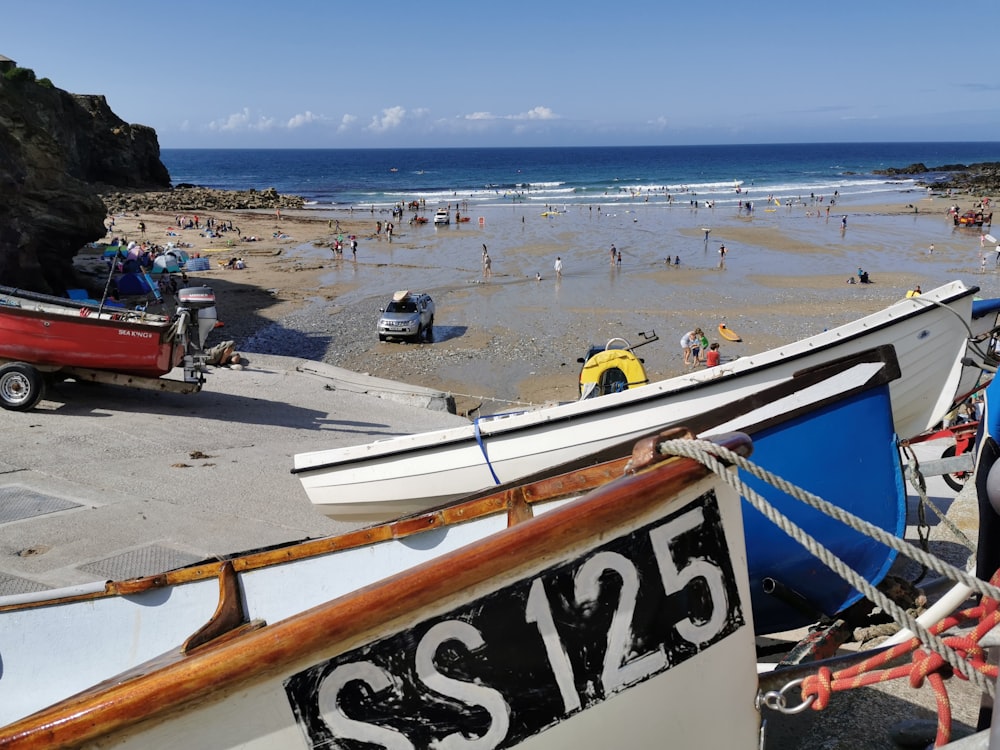 a group of boats sitting on top of a sandy beach