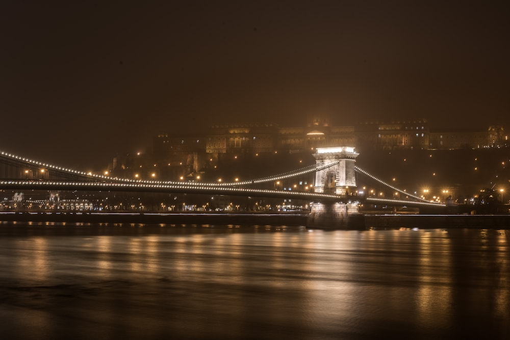 a night view of a bridge over a body of water