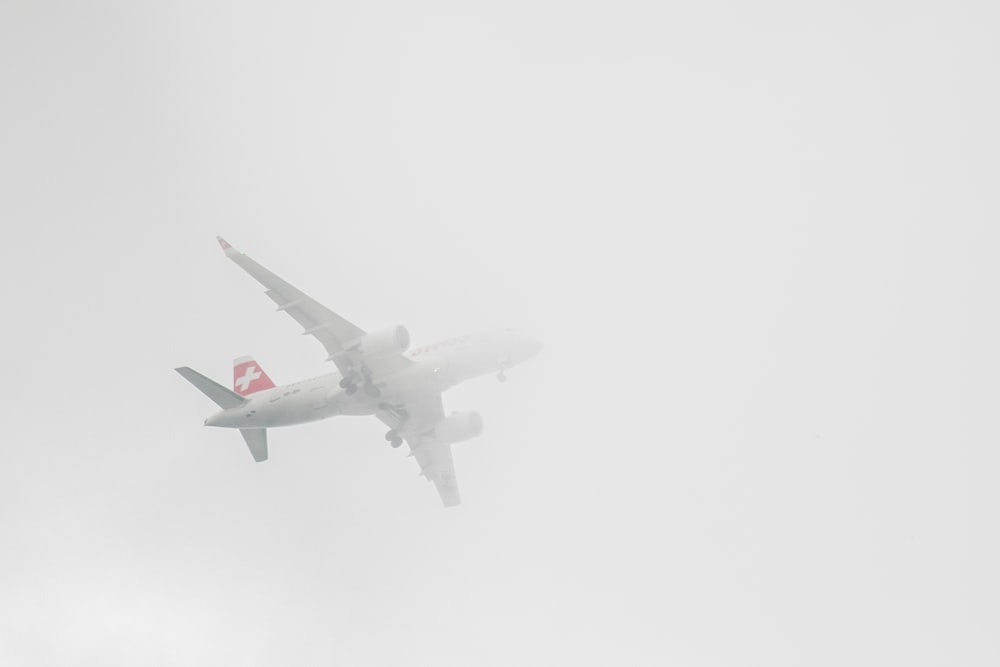 a large passenger jet flying through a foggy sky