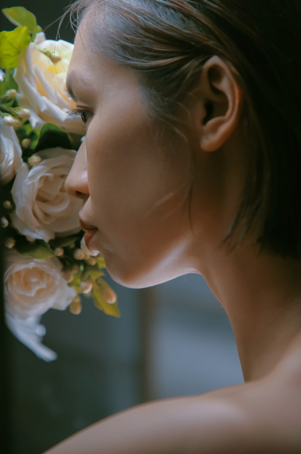 a close up of a woman with flowers in her hair