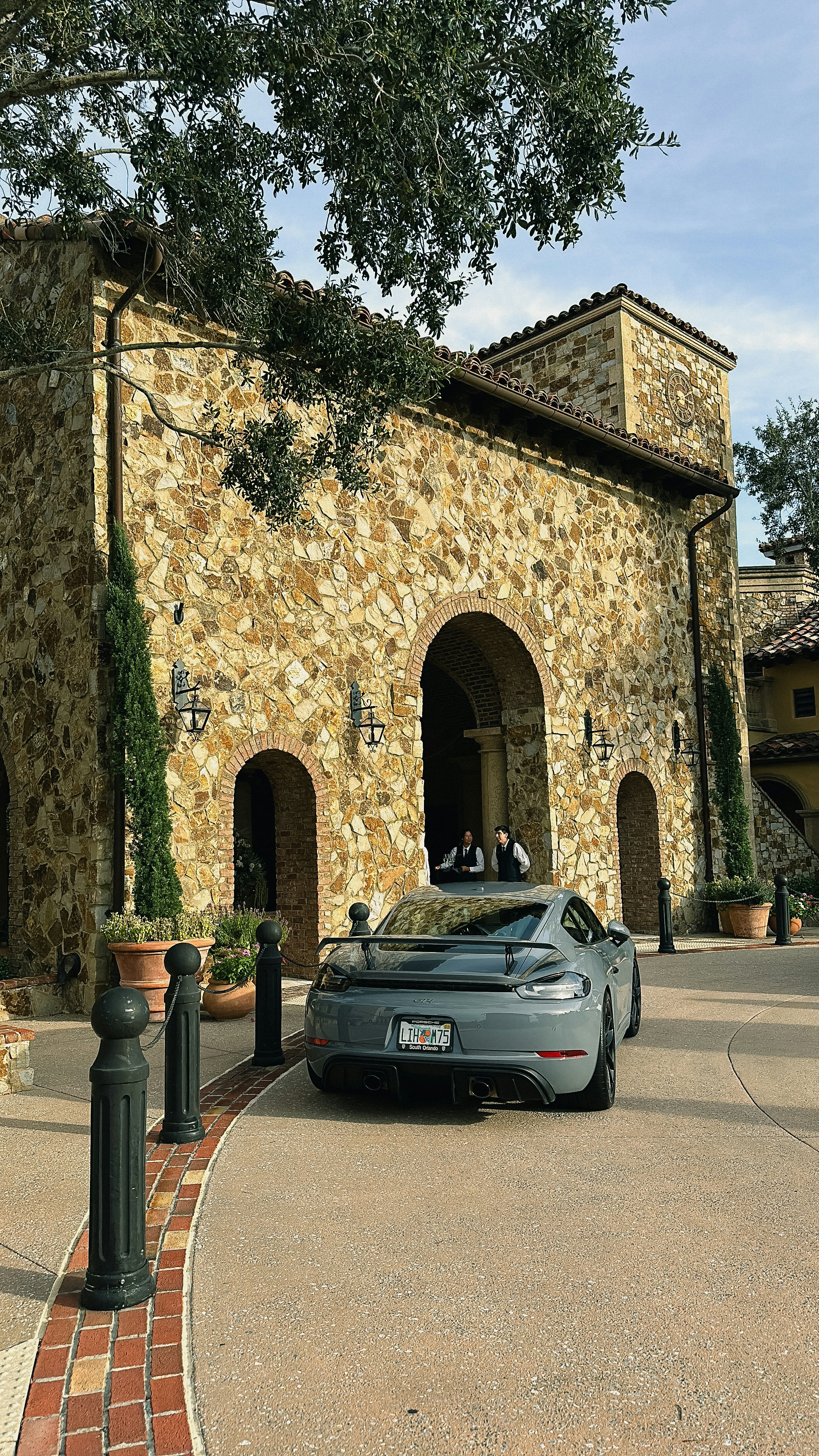 a car parked in front of a stone building