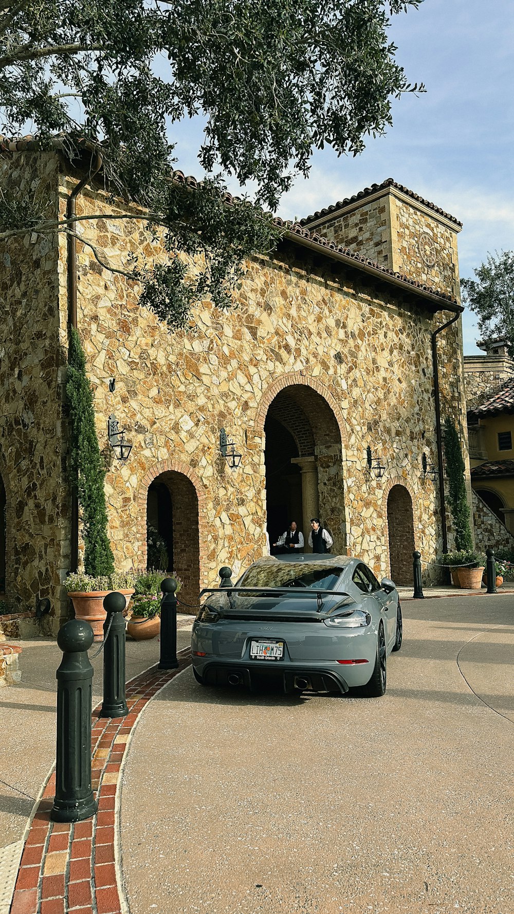 a car parked in front of a stone building