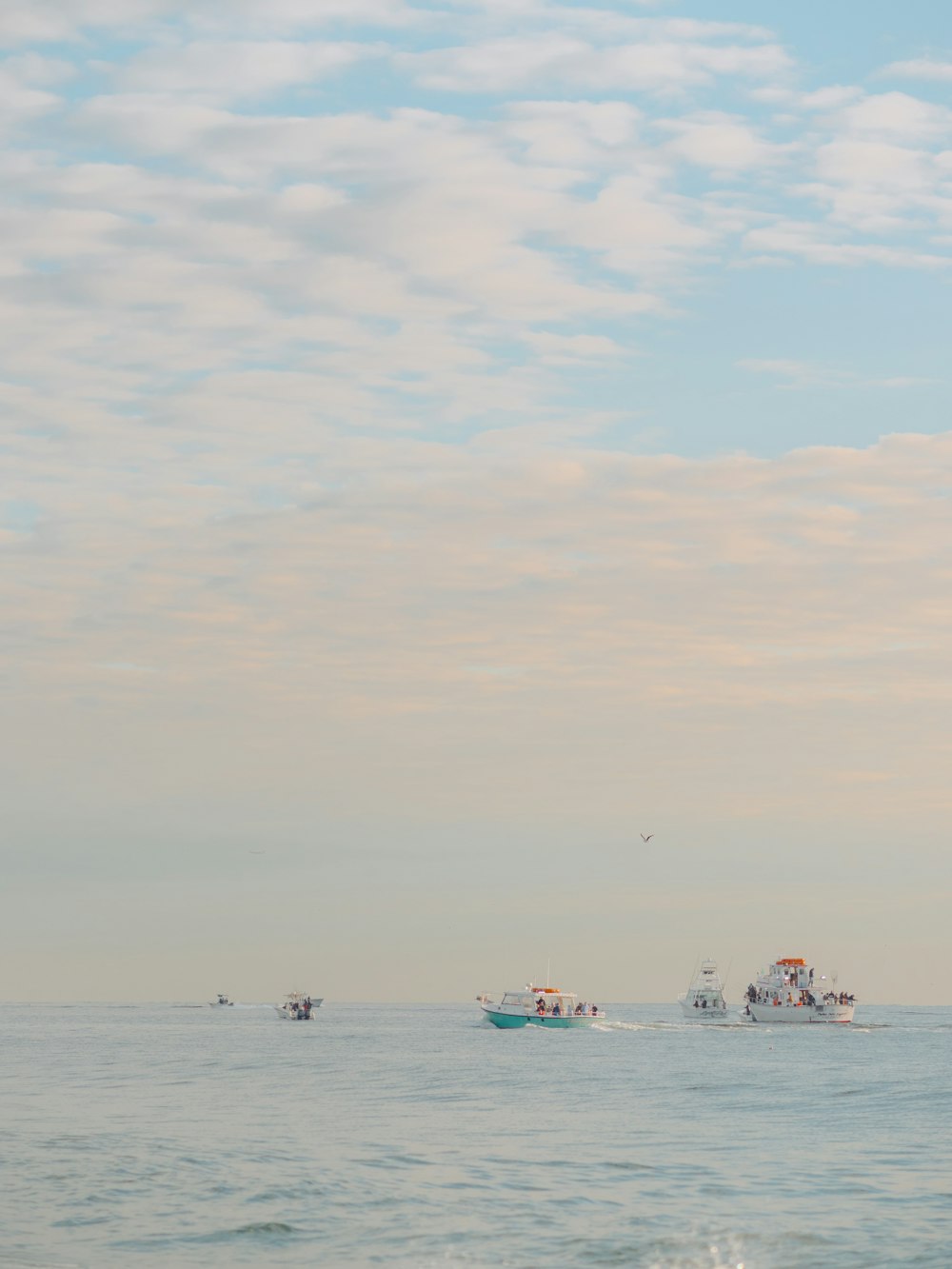 a group of boats floating on top of a large body of water