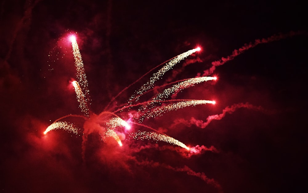 a red fireworks is lit up in the night sky