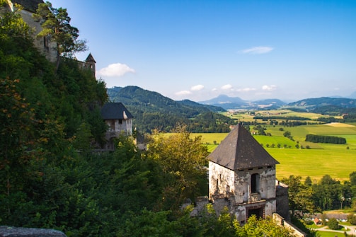 A vibrant scene of a fantasy landscape with mountains and a castle.