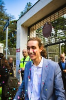 Smiling team members celebrating a successful project launch with blue-themed decorations.