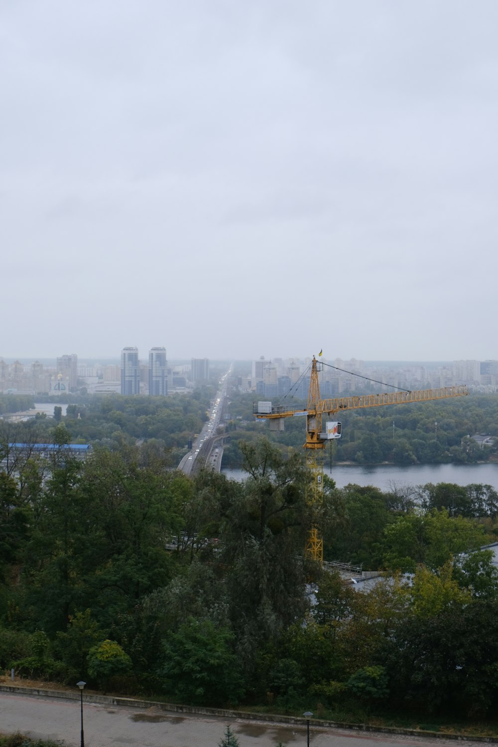 a view of a city with a crane in the foreground
