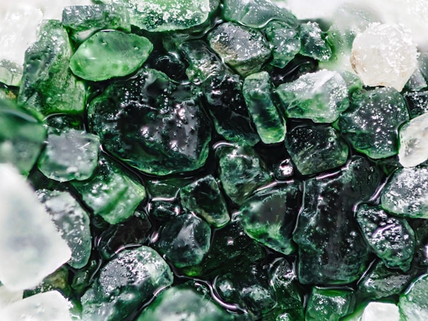 Close-up of intricate sea glass art pieces glistening in sunlight.