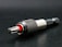 A close-up view of a metallic drill bit adapter featuring a textured, knurled grip and a visible red accent. The tool is placed on a dark surface, highlighting its polished metal components.