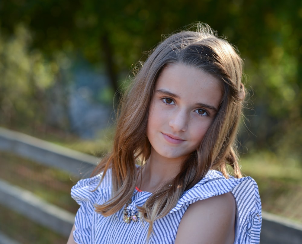 a young girl is posing for a picture