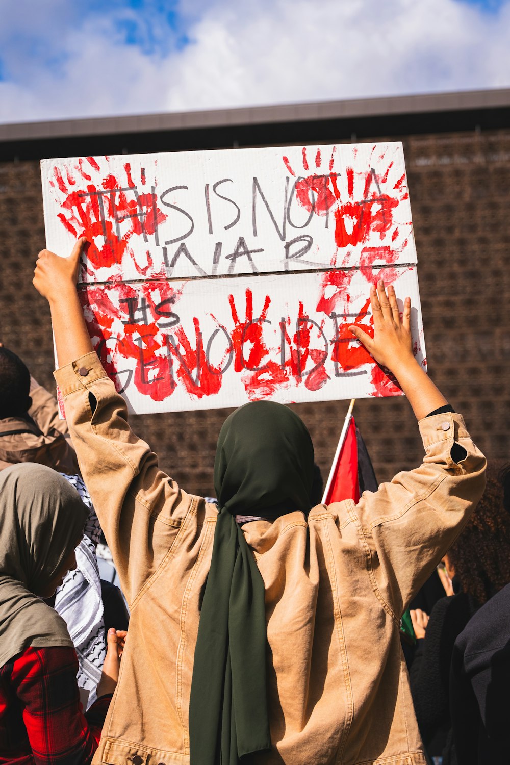 a group of people holding up a sign with writing on it