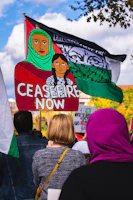 A group of determined South Sudanese activists holding handmade signs during a peaceful protest.