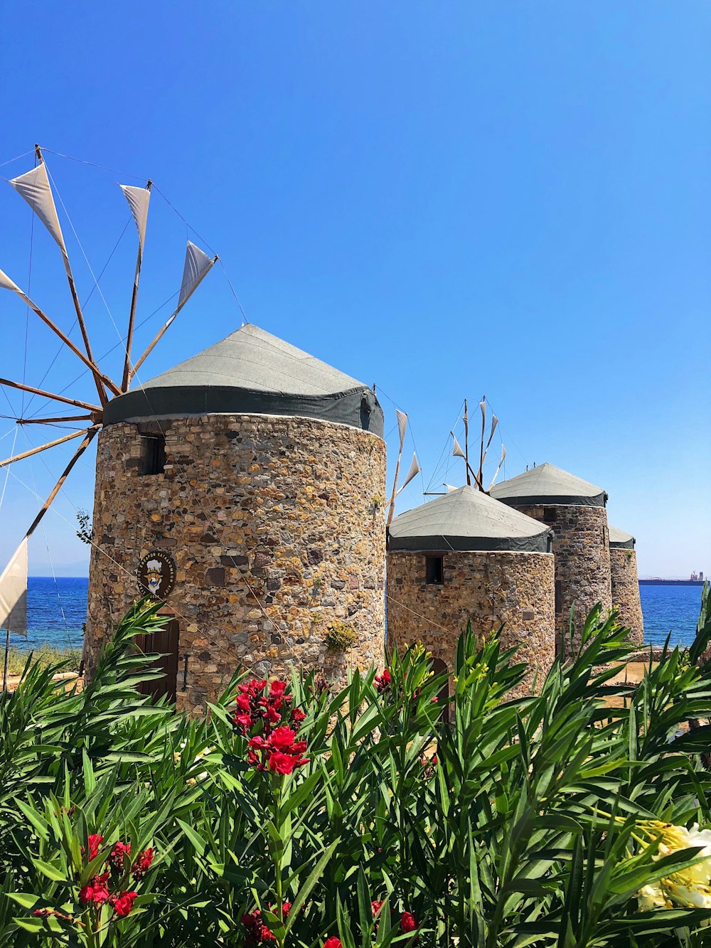 a group of windmills sitting next to a body of water