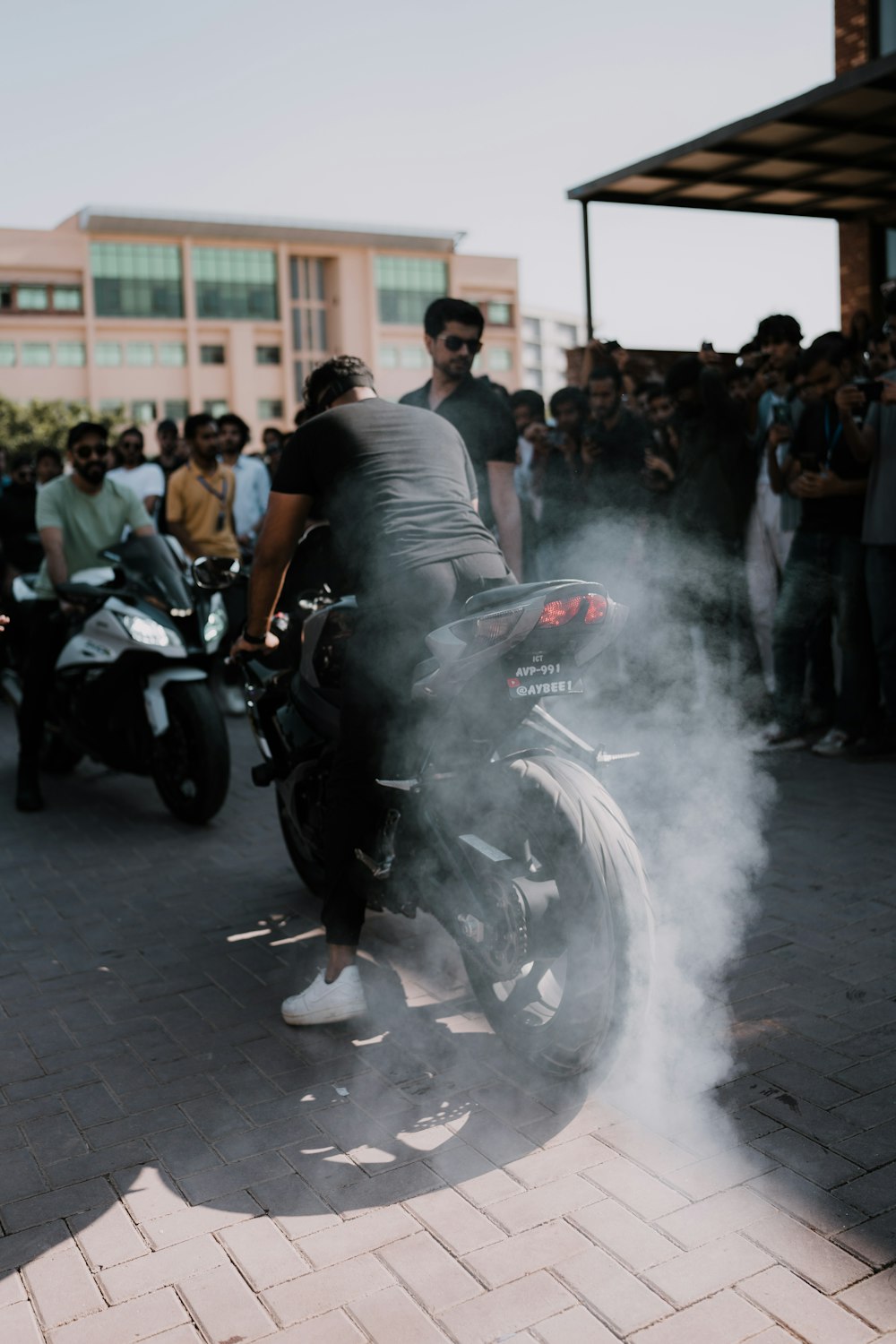 a man riding a motorcycle with a lot of smoke coming out of it