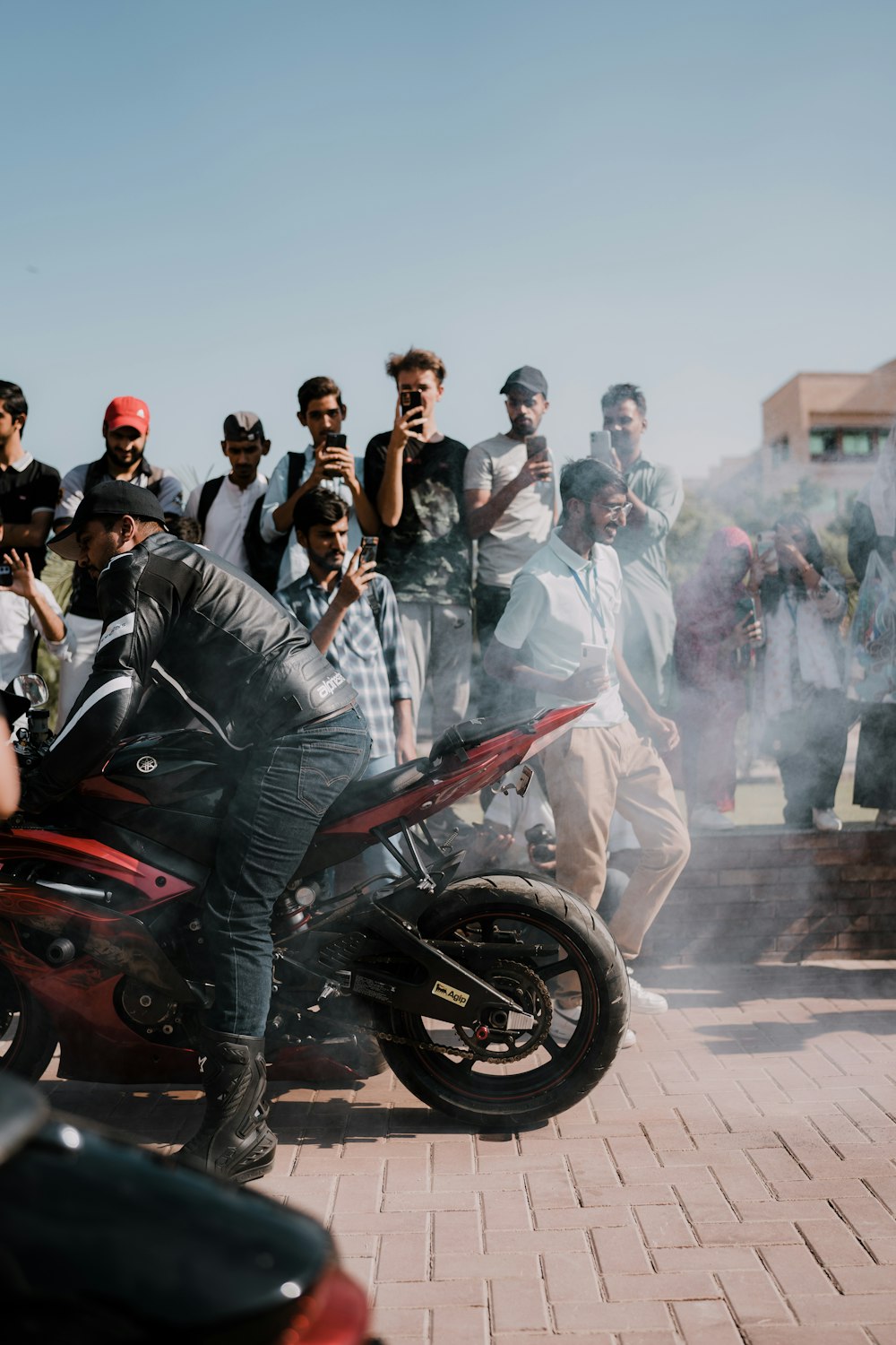 a group of people standing around a motorcycle