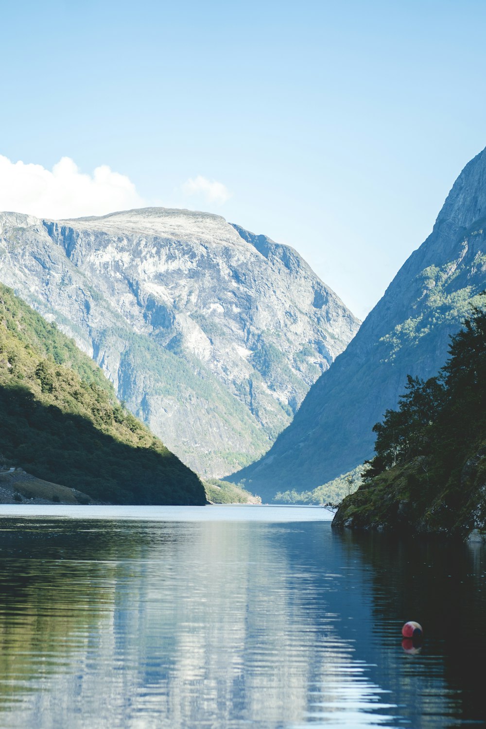 a body of water with mountains in the background