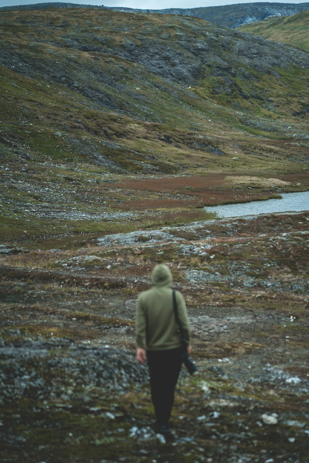 a person with a backpack walking on a hill