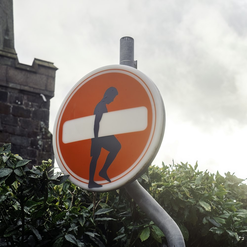 a red and white street sign sitting on top of a metal pole