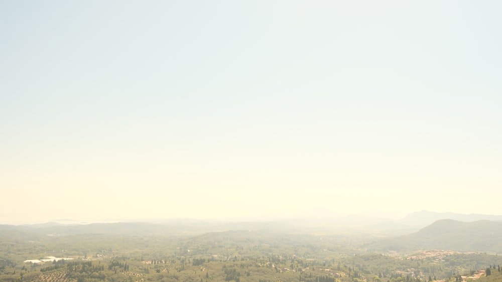 a view of a mountain range with trees in the foreground