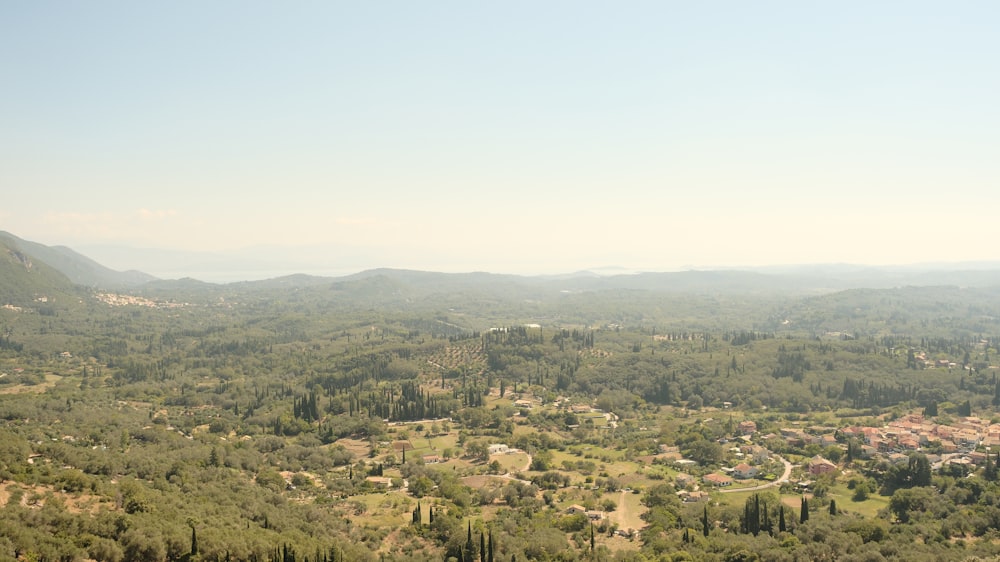 a view of a lush green valley surrounded by mountains