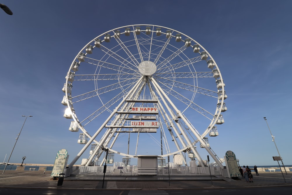 a large ferris wheel sitting on the side of a road