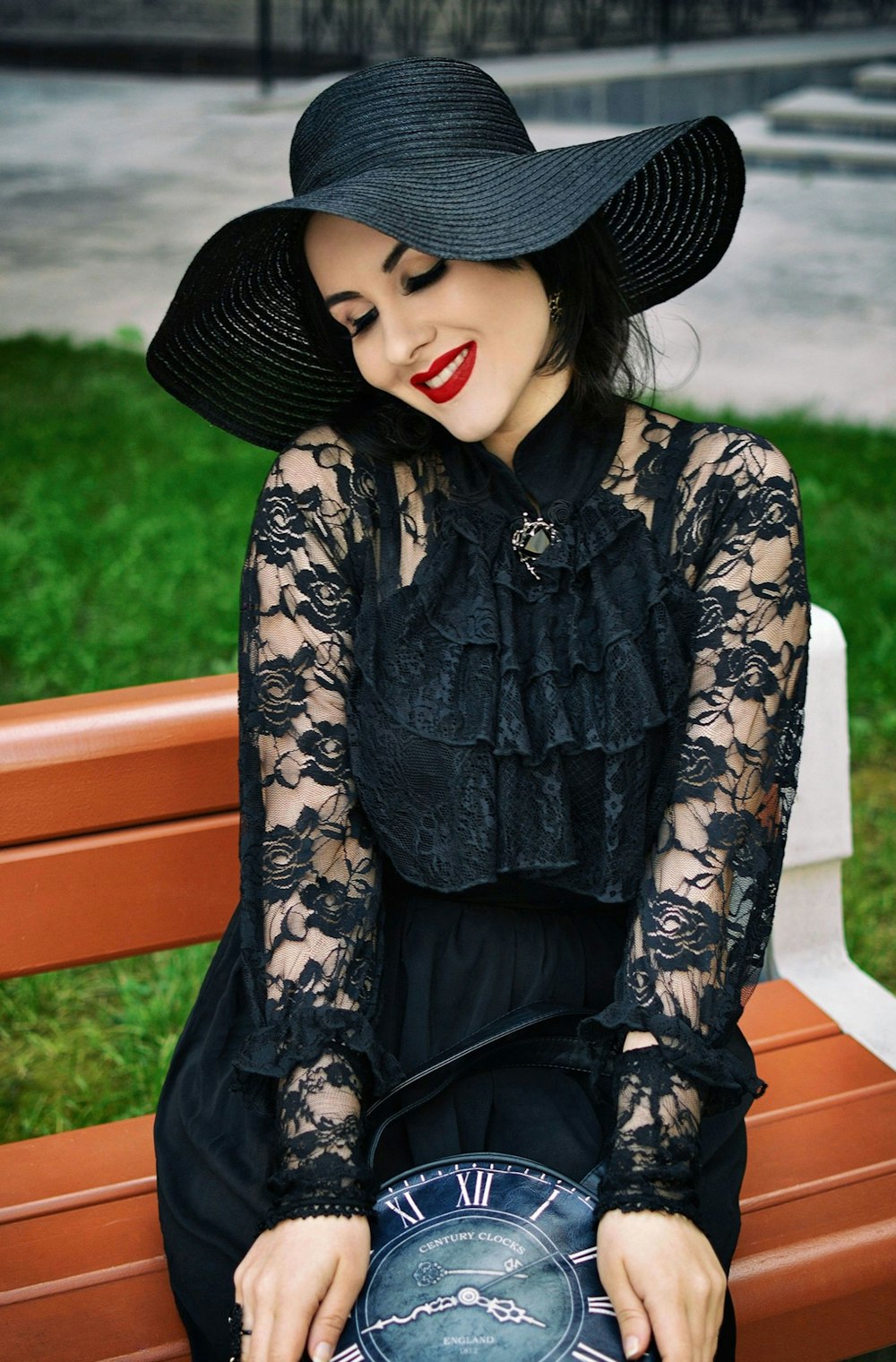 a woman sitting on a bench with a clock