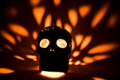 A close-up of a crystal skull glowing softly under museum lights.