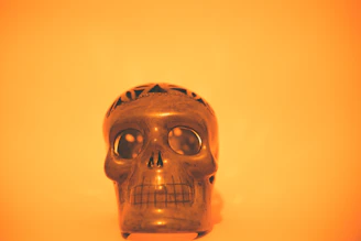 Close-up of a detailed ceramic skull vase with intricate patterns.