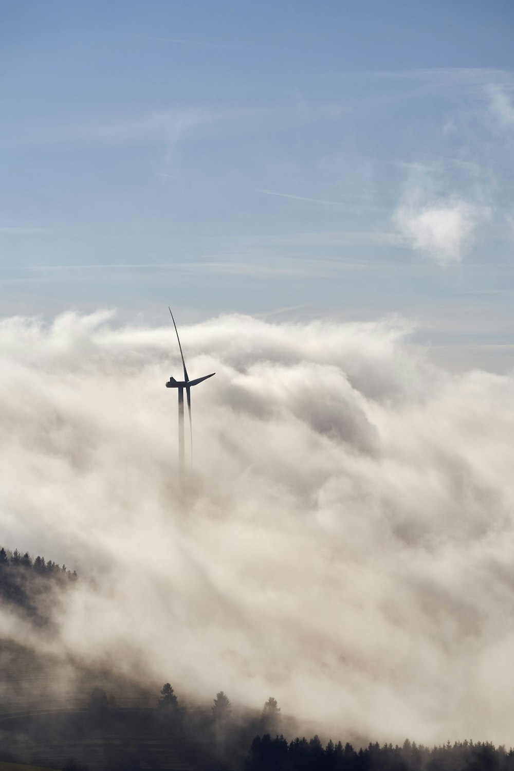 a wind turbine in the middle of a foggy field