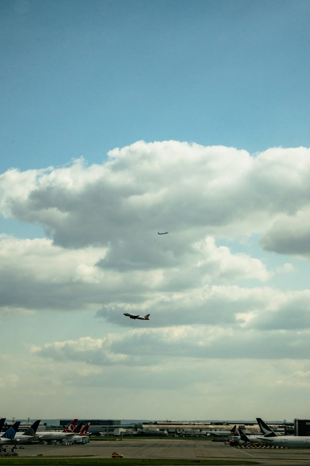 a large jetliner flying through a cloudy blue sky