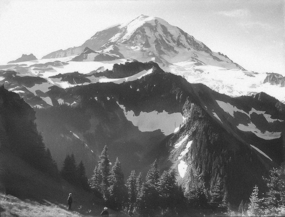 a black and white photo of a snowy mountain