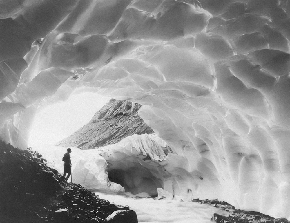 a man standing inside of an ice cave