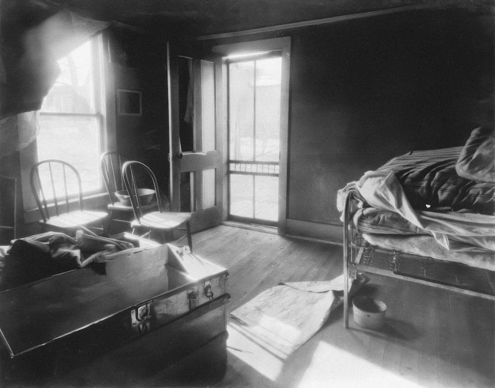 a black and white photo of a bedroom