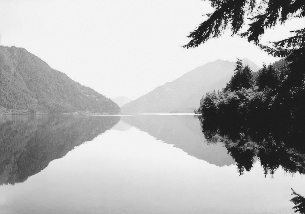 a black and white photo of a mountain lake