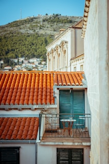 Sunlit balcony of a Casablanca apartment overlooking the vibrant city streets below.