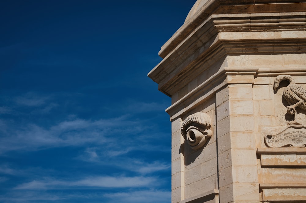 a clock tower with a statue of a bird on it's face