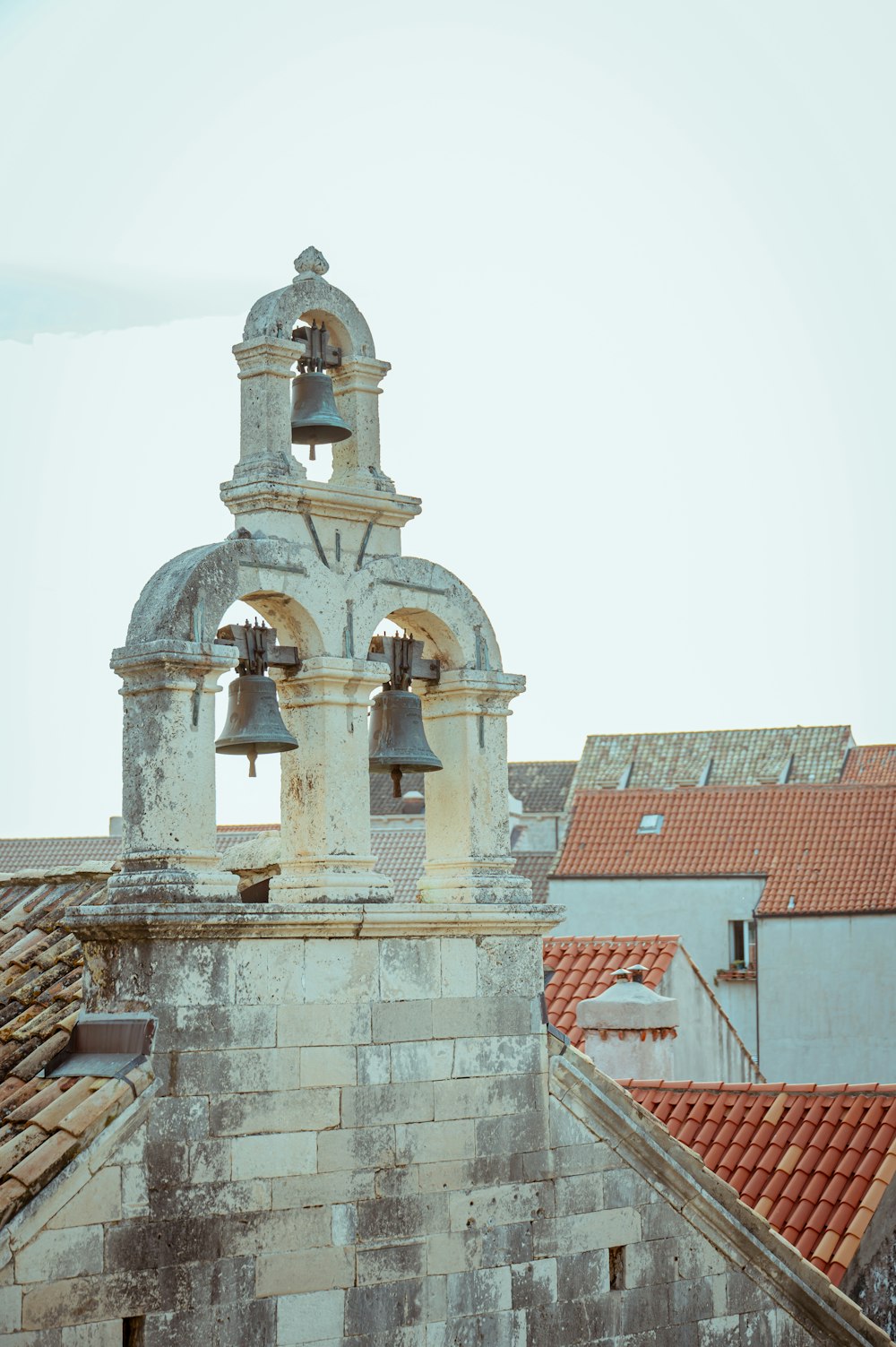 a bell tower with two bells on top of it