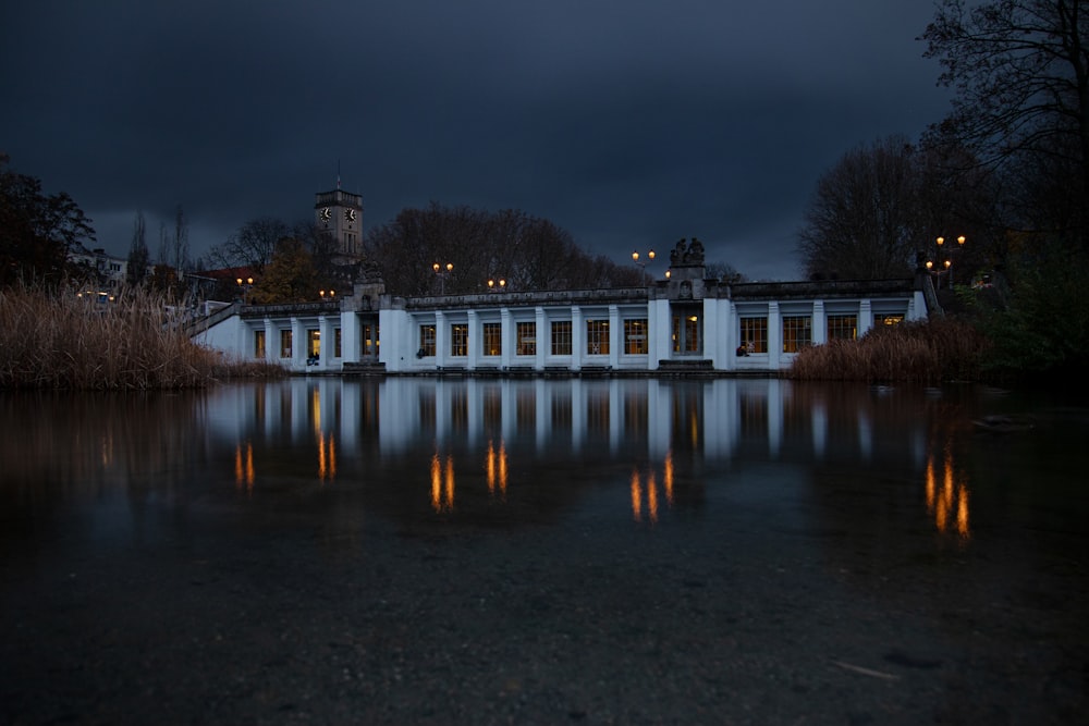 a white building sitting next to a body of water