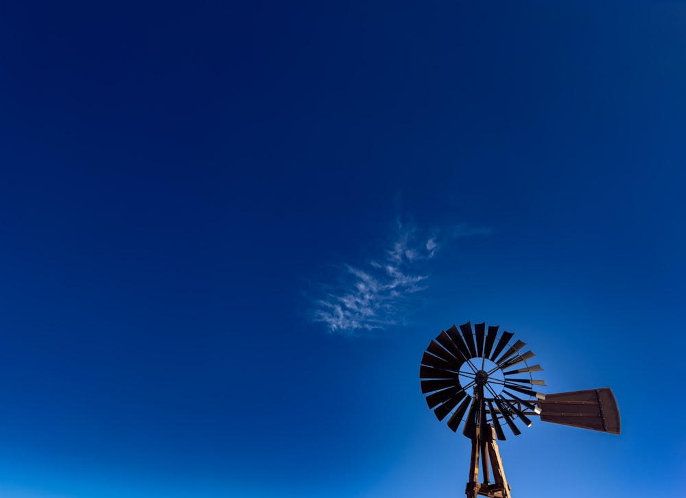 um moinho de vento com um céu azul no fundo