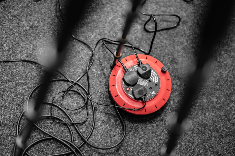 a red and black object sitting on the ground
