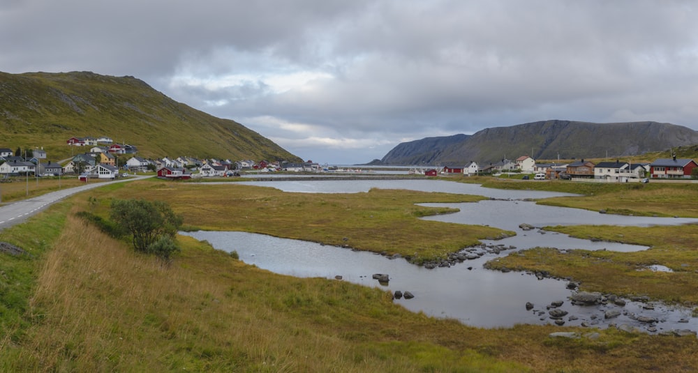 a scenic view of a small town with a river running through it