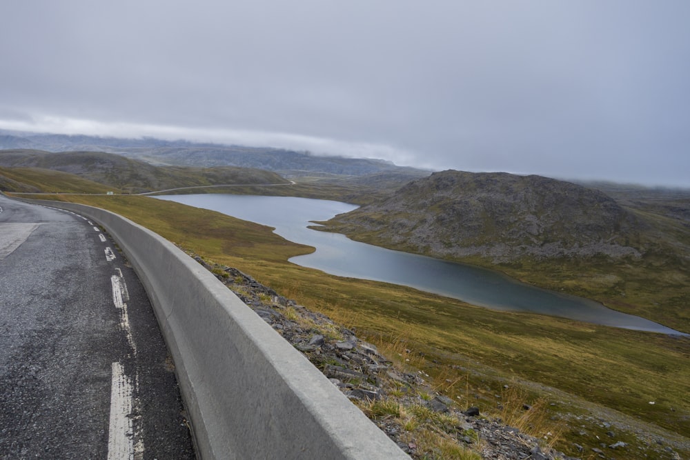 a view of a road with a body of water in the distance