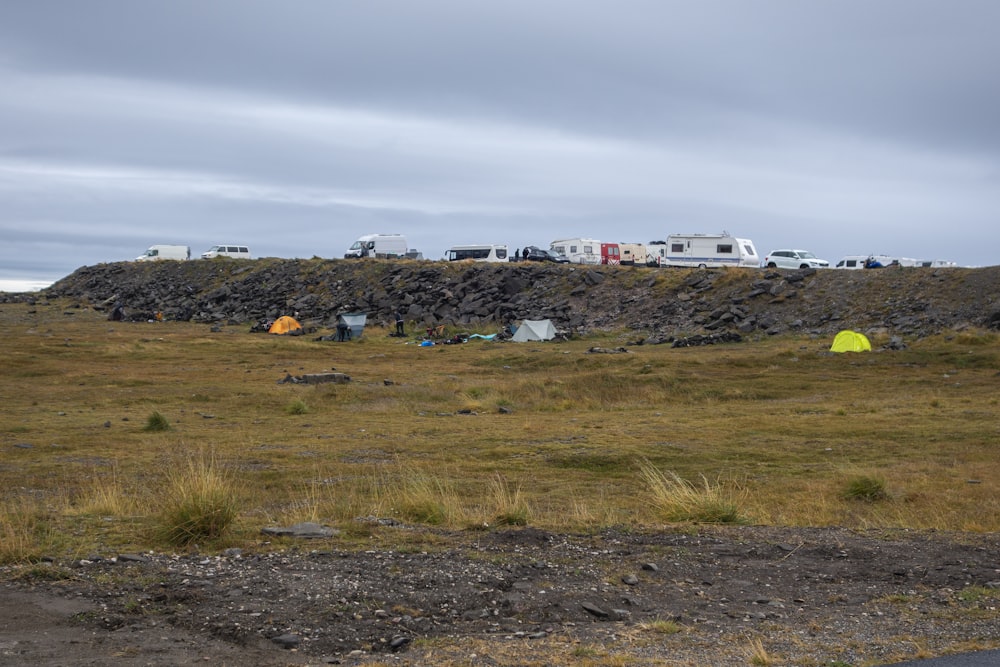 a group of tents sitting on top of a grass covered field