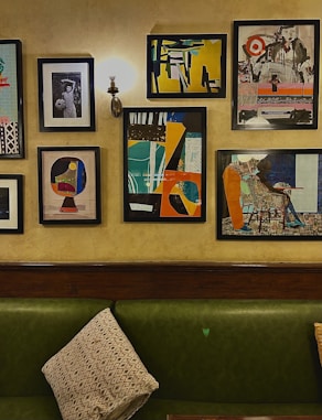 Modern living room featuring a large framed abstract portrait on deep charcoal walls.