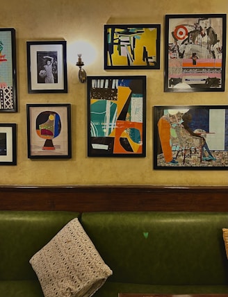 Modern living room featuring a large framed abstract portrait on deep charcoal walls.